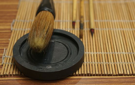Chinese writing brush and ink stone on Keep brush mat.