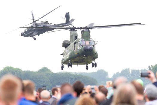 LEEUWARDEN, THE NETHERLANDS - JUN 11, 2016: Dutch Chinook and Apache helicopter flying during the Royal Netherlands Air Force Days