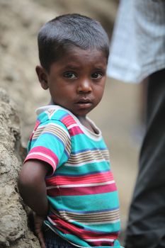 A portrait of a poor little boy from India in his unfortunate condition.