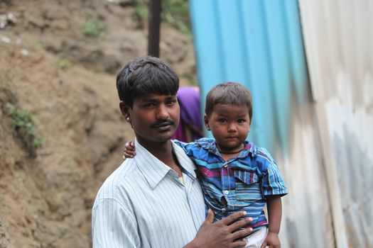  A little boy with his poor father who is a construction worker, in India