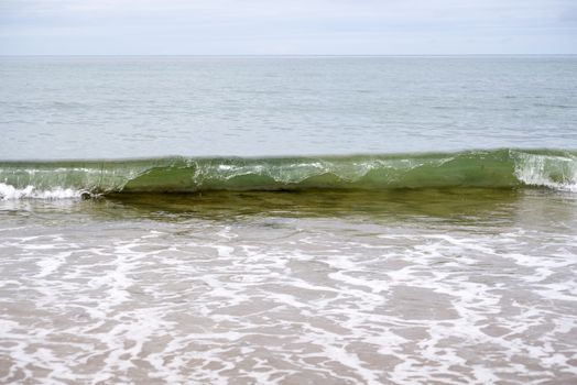 clean green waves breaking on the beach in ballybunion county kerry ireland