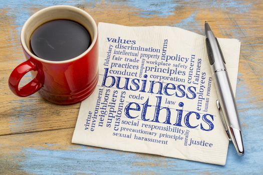 business ethics word cloud - handwriting on a napkin with cup of coffee