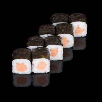 Sushi rolls with salmon on  black background