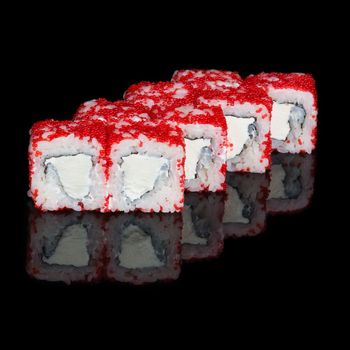 Sushi rolls with soft cheese and flying fish roe on black background