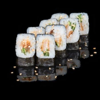 Sushi rolls with eel and cucumber on  black background