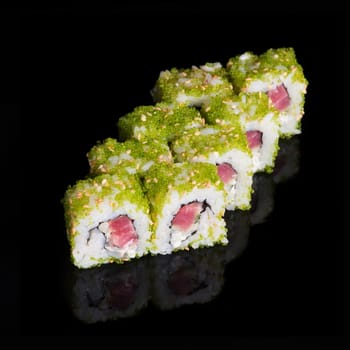Sushi rolls with tuna, cucumber and flying fish roe on black background