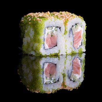 Sushi rolls with salmon, cucumber and flying fish roe on black background