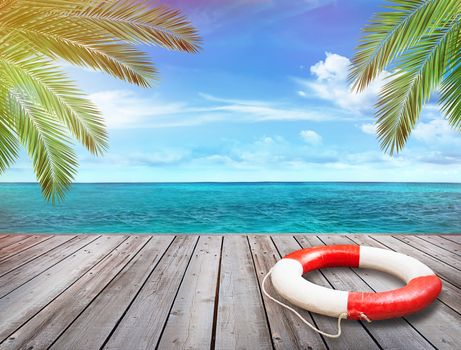 Wood pier with ocean and palm trees