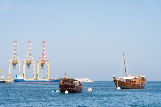 Classic Arabic wooden dhows at the commercial harbour in Muscat, Oman.