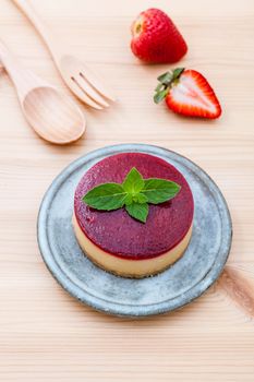 Strawberry cheesecake with fresh mint leaves on wooden background. Selective focus depth of field.