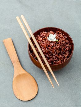 Steamed traditional thai rice in bowl with spoon high fiber and vitamin E for dietary and healthy food.