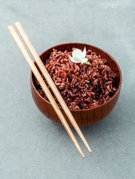 Steamed traditional thai rice in bowl with spoon high fiber and vitamin E for dietary and healthy food.