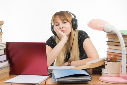 Student thinking and looking with interest at a laptop