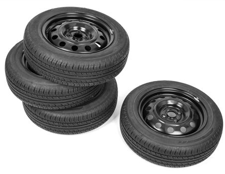 Stack of four wheel new black tyres, isolated on white background