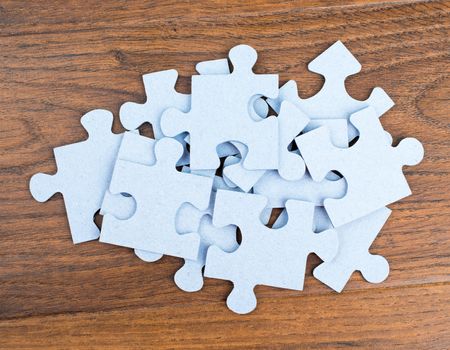 Pile of puzzle pieces on table, top view