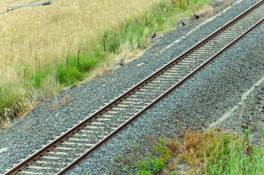 A oblique shot of railroad tracks extending to the out picture
