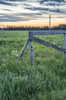 Wooden Fence in Field at sunrise.