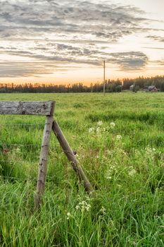 Wooden Fence in Field at sunrise.