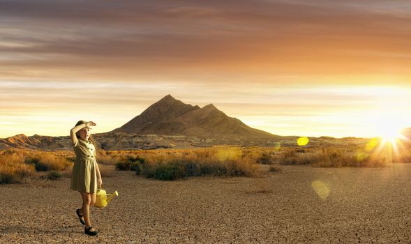 Portrait of little white girl walking through the desert during sunset