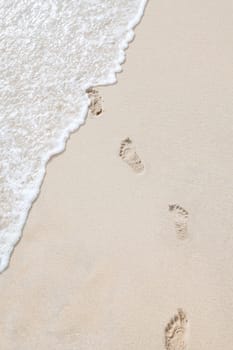 view of human steps on summer sandy beach