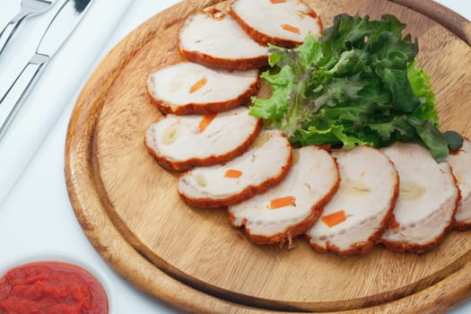 Close up view of cold boiled sliced pork with red sauce