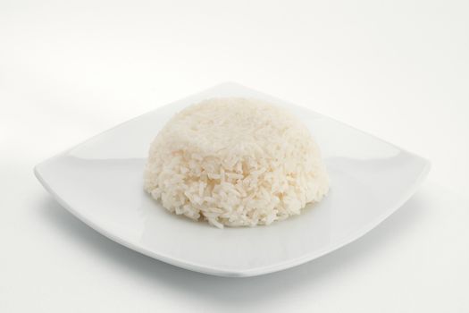 Close up view of plate of   fresh Plain rice on white back