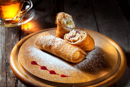 view of nice fresh hot crepes with fruit dessert  on color background
