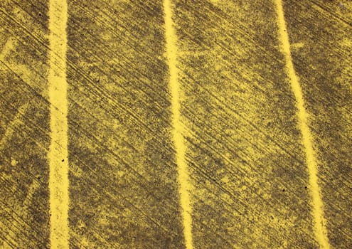 Pattern with yellow stripes painted on asphalt