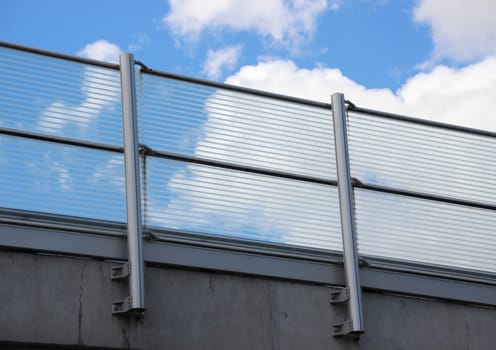Metal and glass railing with blue sky perspective