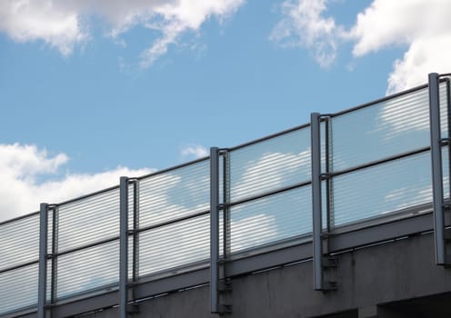 Metal and glass railing with blue sky perspective