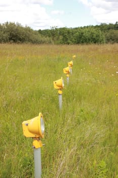 Yellow Runway landing lights in grass field