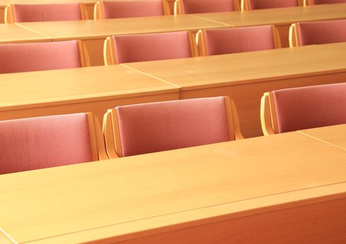 Empty conference room with wooden chairs facing front