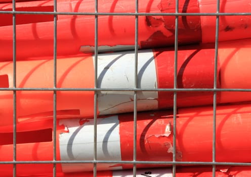 Orange warning tubes in metal grid