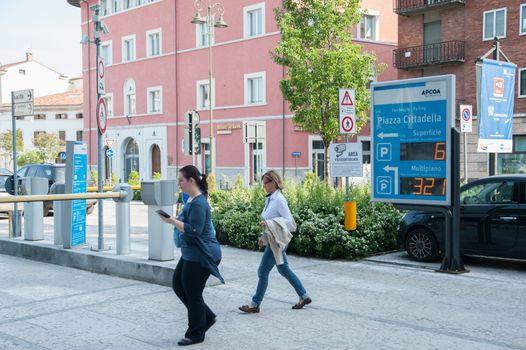 Verona centre underground parking entrance, and people passing