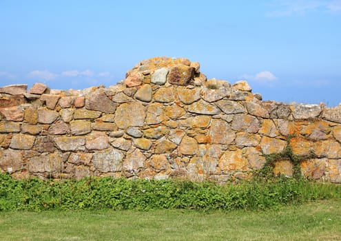 Ancient ruin wall of rocks with blue sky