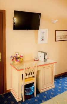 Details of an hotel room: desk and tv corner, including minibar and exspresso coffee machine.