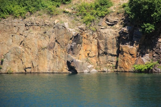 Lake with rocks and abrupt cliff hang