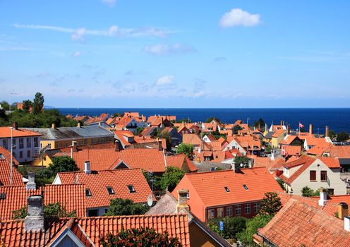 Red roofs and ocean at Gudhjem town in Denmark
