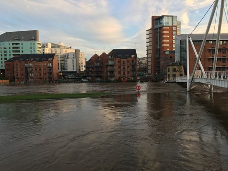 UNITED-KINGDOM, Leeds : Parts of Leeds near the Royal Armouries museum are submerged in flood waters after heavy rainfall hits northern England on December 27, 2015 in West Yorkshire. December 2015 has been the wettest on record for parts of the UK and has seen several communities swamped by rising waters, Met Office figures show. Flood alerts and warnings were issued since the beginning of the month across England and Wales as Storm Desmond, Eva then Frank take hold and bring torrential rain. The leader of Leeds City Council has said the authority had warned the Government that flooding in Leeds was a catastrophe waiting to happen on December 27, 2015. 