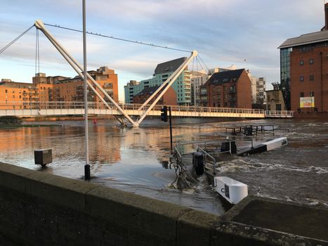 UNITED-KINGDOM, Leeds : Parts of Leeds near the Royal Armouries museum are submerged in flood waters after heavy rainfall hits northern England on December 27, 2015 in West Yorkshire. December 2015 has been the wettest on record for parts of the UK and has seen several communities swamped by rising waters, Met Office figures show. Flood alerts and warnings were issued since the beginning of the month across England and Wales as Storm Desmond, Eva then Frank take hold and bring torrential rain. The leader of Leeds City Council has said the authority had warned the Government that flooding in Leeds was a catastrophe waiting to happen on December 27, 2015. 