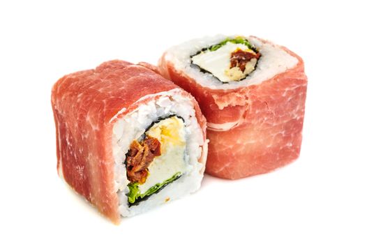Uramaki maki sushi with prosciutto crudo, two rolls isolated on white. Letuce, philadelphia cheese, dried tomatoes, parmigiano