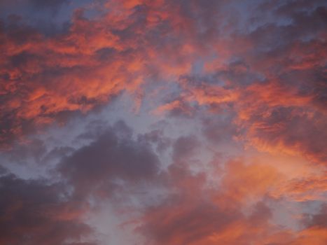 Dramatic purple sky and red gray cloudy at sunset for background