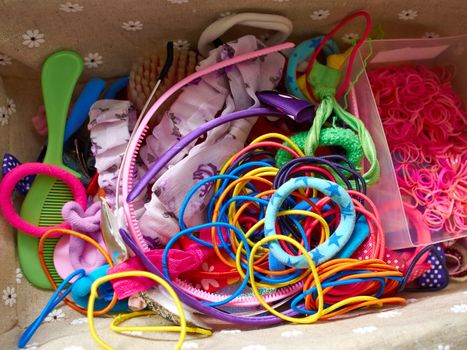 Colorful hair bands and style accessories in a young girl beauty case
