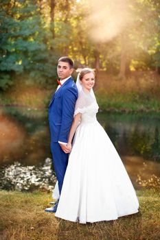 Funny bride and groom on a summer day in the park