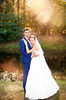 Funny bride and groom on a summer day in the park