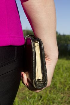 Athlete woman holding a brown diary outdoors