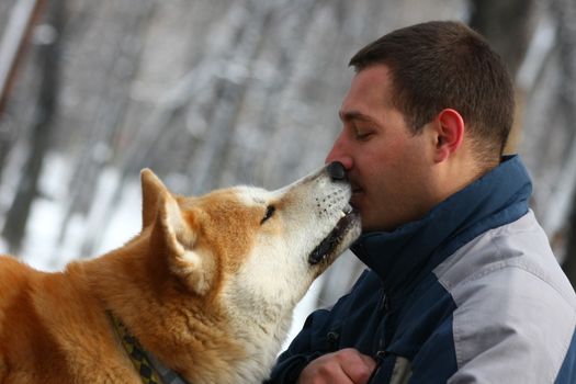 Man and his dog share piece of cracker