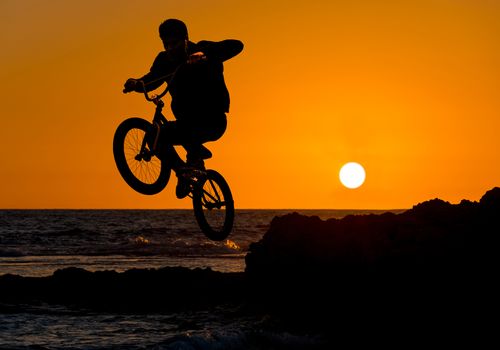 extreme sport bmx, jump on a sunset background