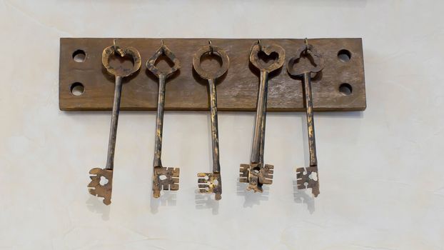 Old keys with key hanging on a white wall of an old hotel