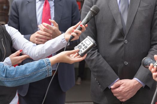 Reporters making interview with businessman or politician